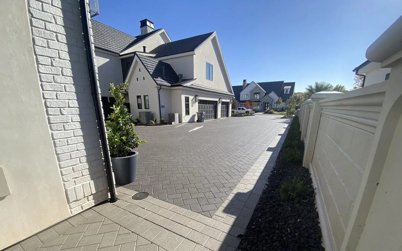Luxury dark herringbone paver driveway sealed — new construction Southern Utah